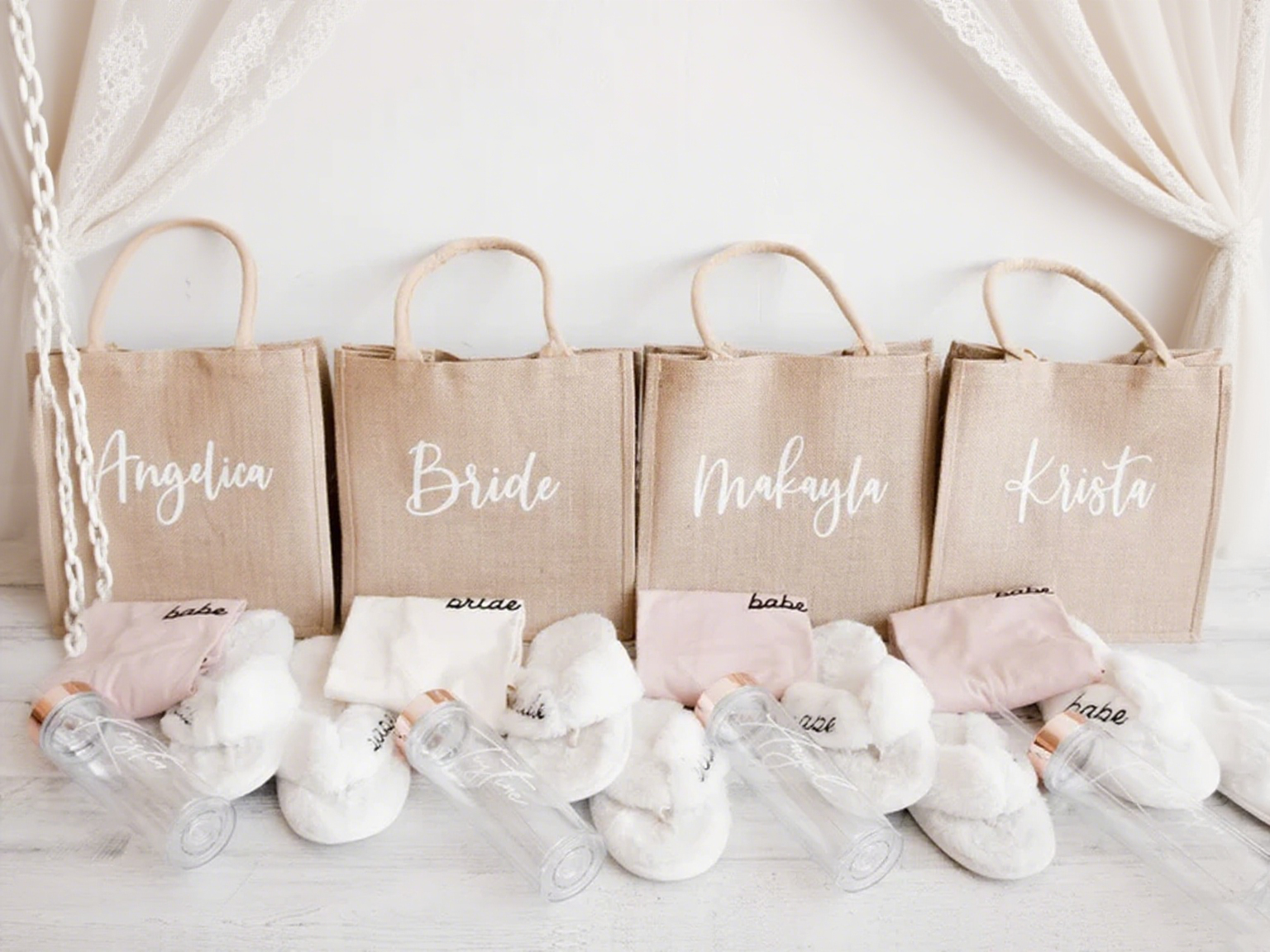 A personalized name burlap tote bag with bridesmaid gifts next to it